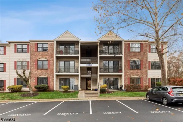 a front view of a residential apartment building with a yard