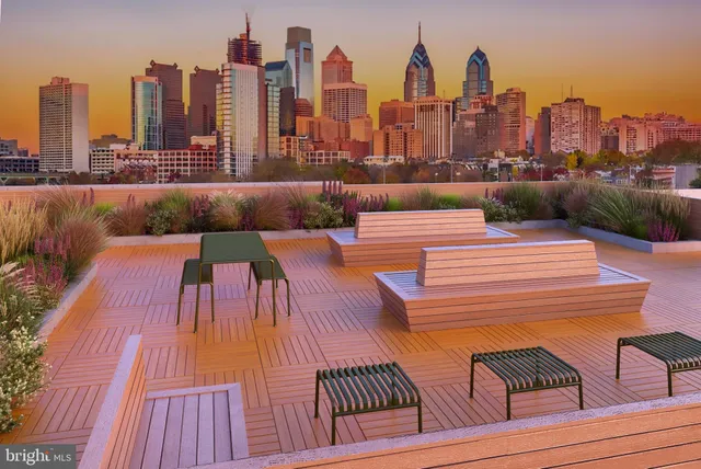 a view of roof deck with outdoor seating and city view
