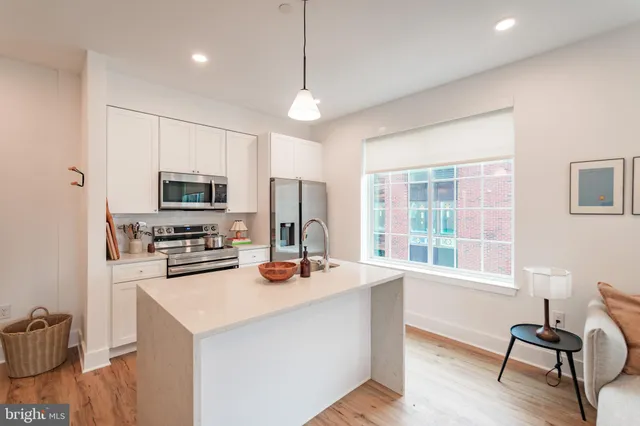 a kitchen with stainless steel appliances a stove sink refrigerator and microwave