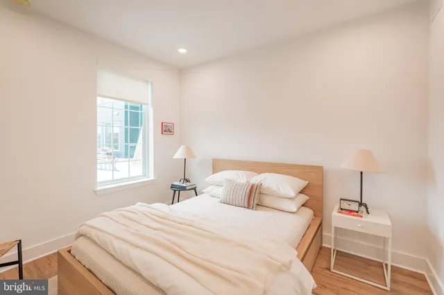 a bedroom with a bed and a window