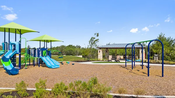 a view of a swimming pool with a lawn chairs under an umbrella