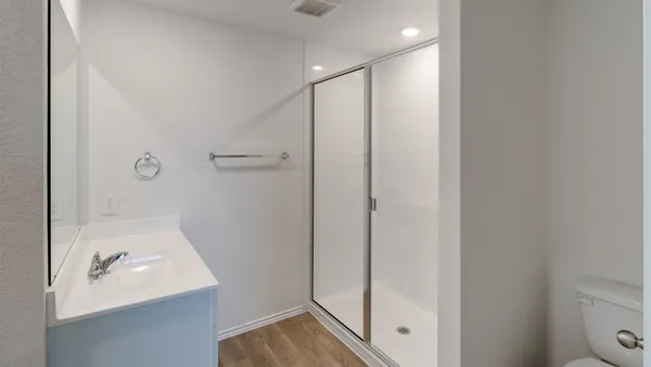 a bathroom with a shower sink and toilet
