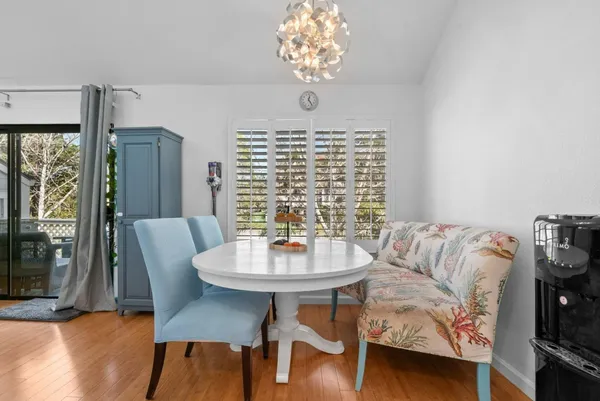 a view of a dining room with furniture window and wooden floor