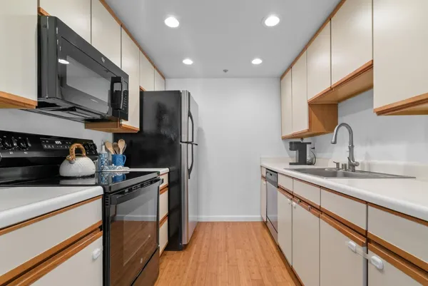 a kitchen with a stove and a refrigerator