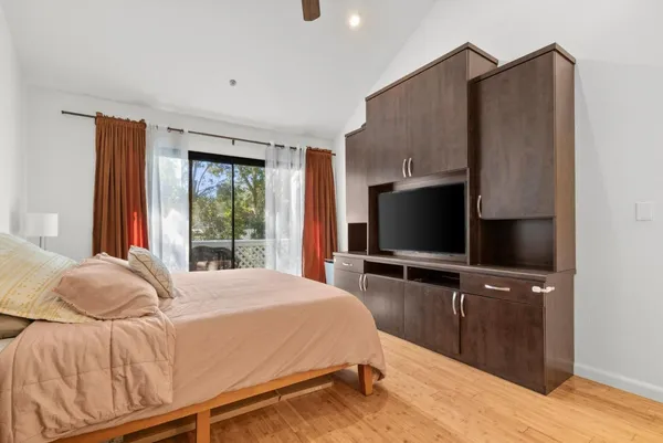 a bedroom with a bed and a night stand