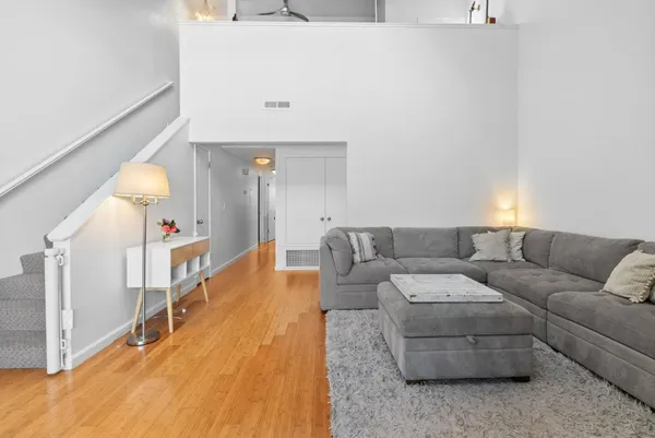 a living room with furniture and wooden floor