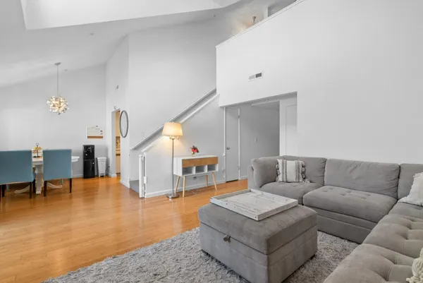 a living room with a fireplace and a floor to ceiling window