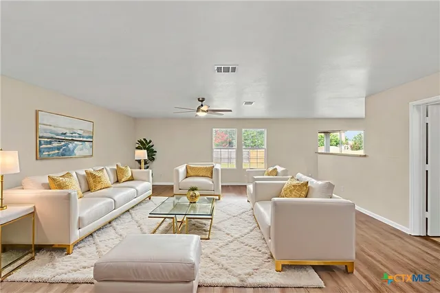 a living room with furniture and a large window