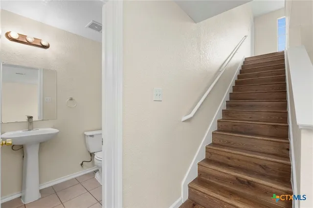 a view of a hallway with wooden floor and entryway