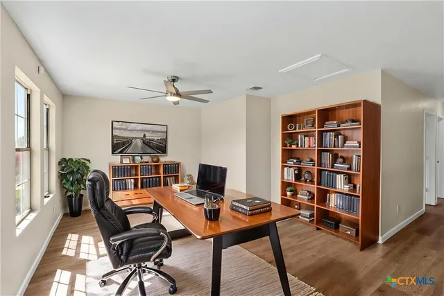 a workspace with a bookshelf and a workspace
