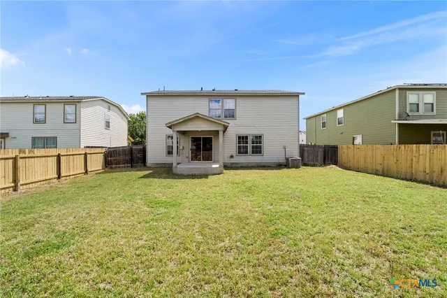 a swimming pool with outdoor seating and yard