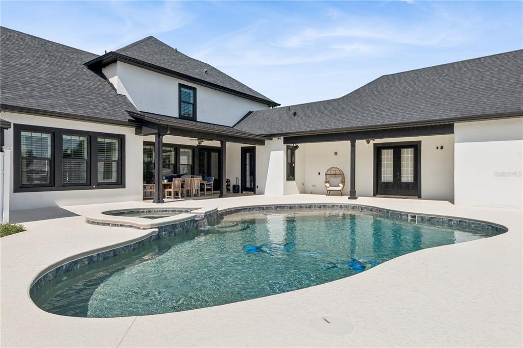 345 Cypress Isles Road Osteen, FL 32764 - Photo 2 of 41 a view of a house with pool plants and couches