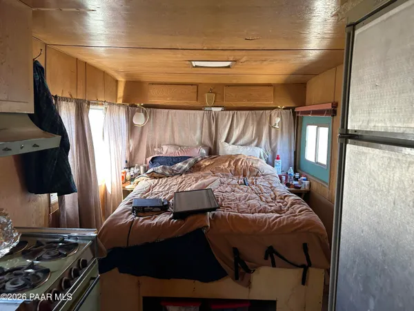 a bed sitting in a bedroom next to a window