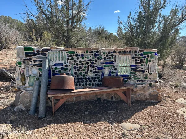 a view of a chairs and table in backyard