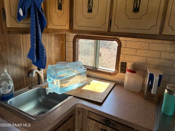 a kitchen with a sink and a stove top oven