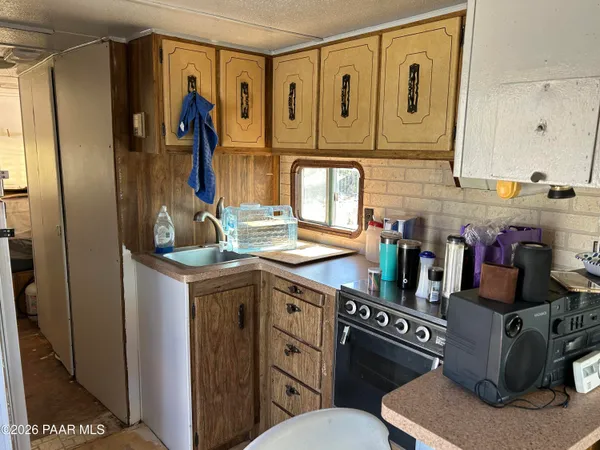 a kitchen with stainless steel appliances a sink and cabinets