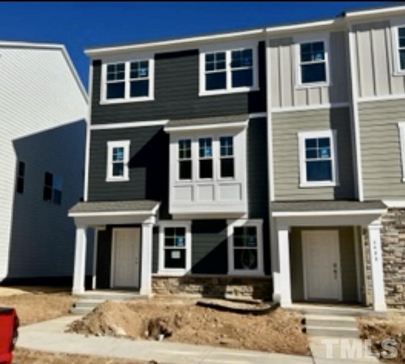 6410 Nurture Avenue, Unit 3272 Raleigh, NC 27616 - Photo 3 of 5 a front view of a building with a garden