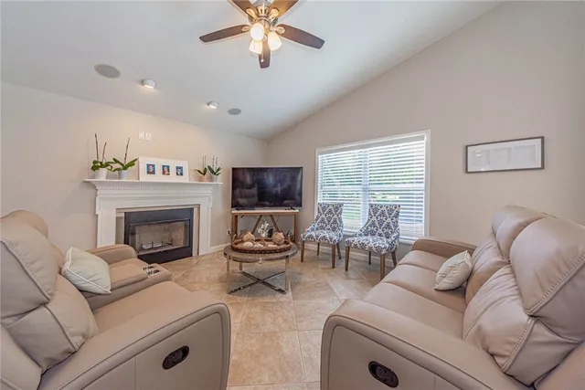 a living room with furniture a large window and a fireplace