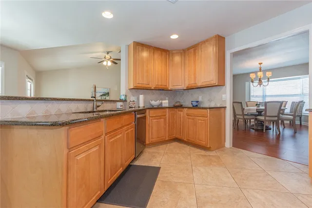 a kitchen with stainless steel appliances granite countertop a sink counter space and cabinets