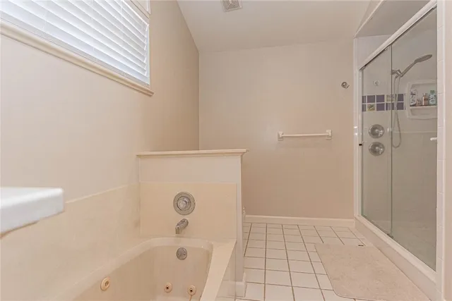 a bathroom with a bathtub and a shower