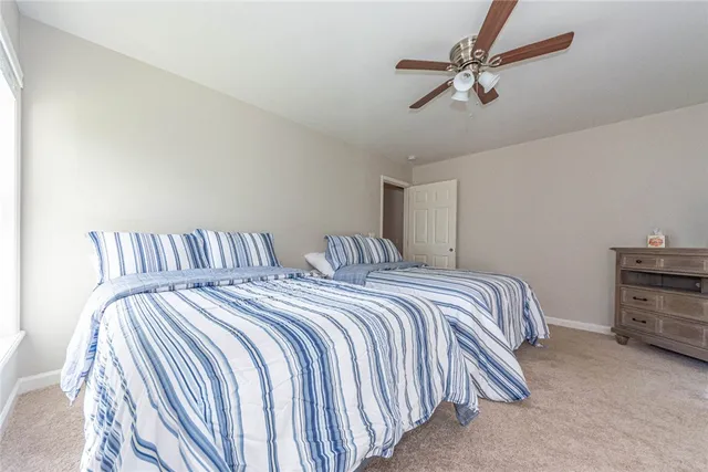 a bedroom with bed and a chandelier