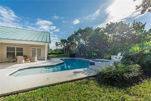 a view of house with yard outdoor seating and barbeque oven