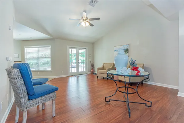 a living room with furniture and a wooden floor
