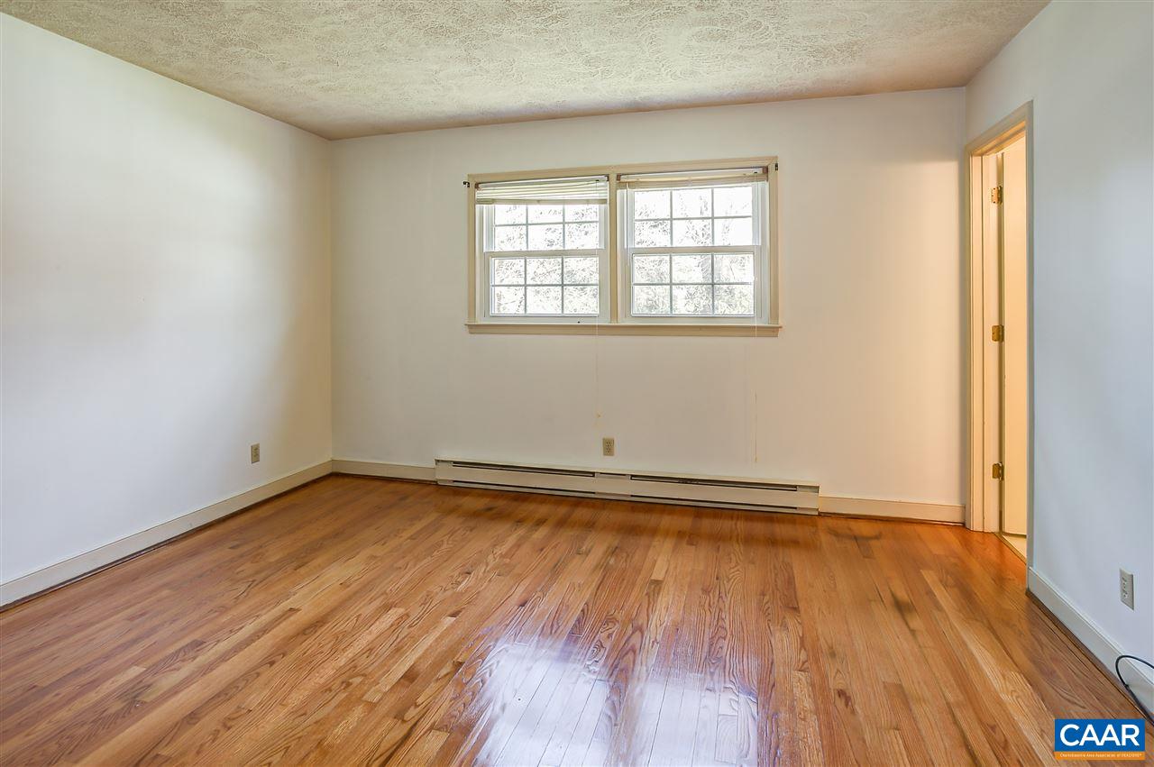 2711 Huntington Road Charlottesville, VA 22901 - Photo 22 of 39 an empty room with wooden floor and windows