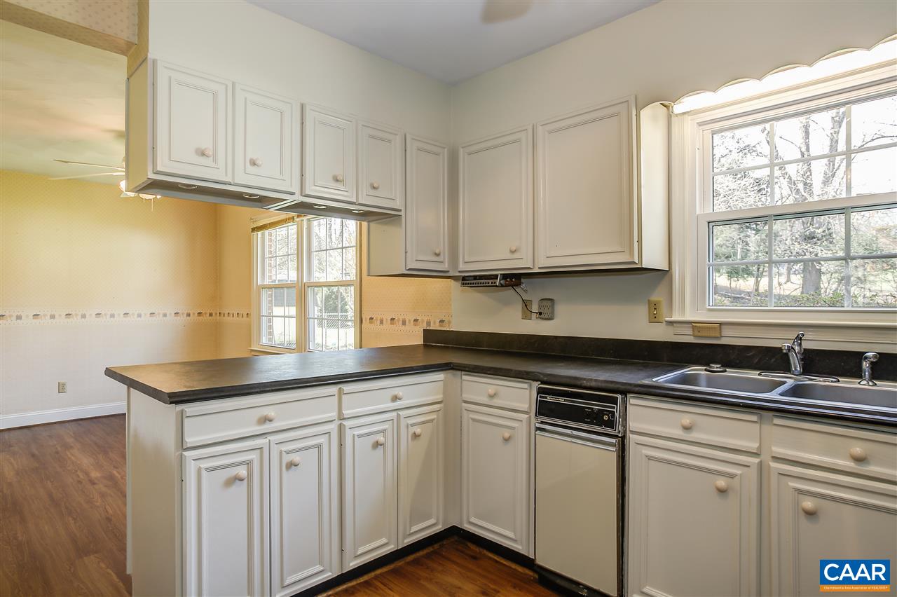 2711 Huntington Road Charlottesville, VA 22901 - Photo 4 of 39 a kitchen with granite countertop white cabinets and a window