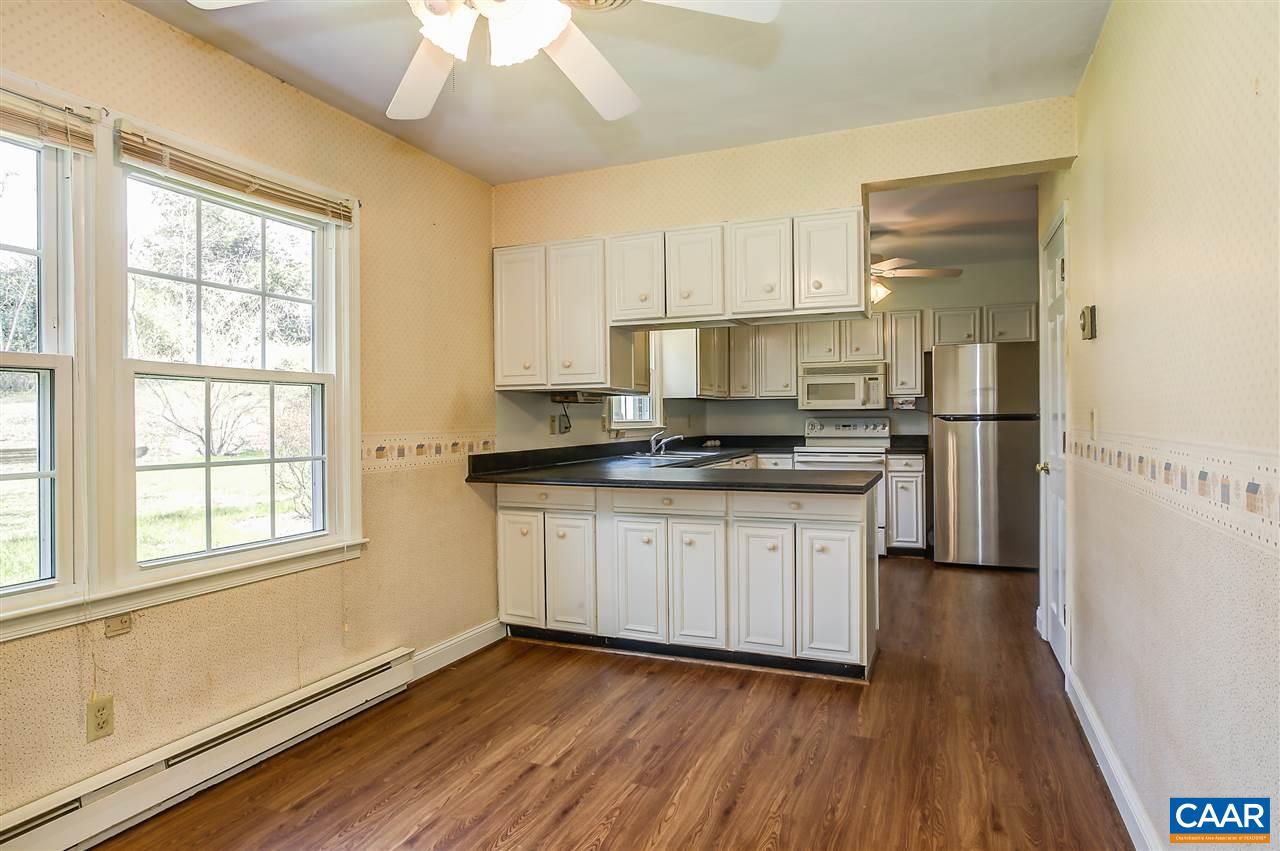 2711 Huntington Road Charlottesville, VA 22901 - Photo 5 of 39 a kitchen with granite countertop white cabinets and wooden floor