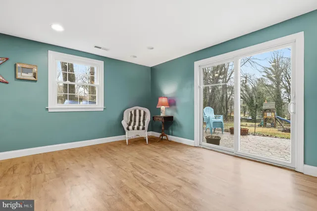 a view of house with a big yard and potted plants