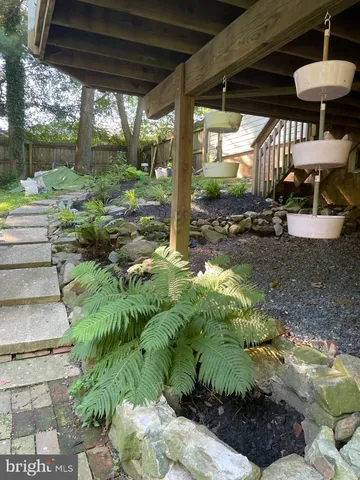 a view of a room with wooden floors and a fireplace