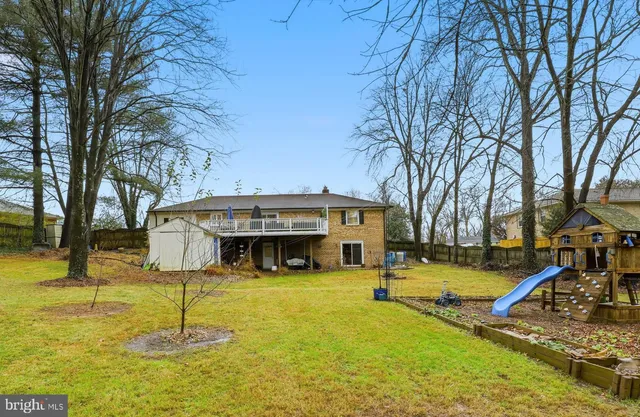 a front view of a house with yard patio and swimming pool
