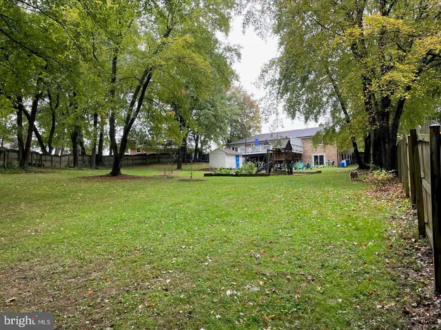 a bedroom with bed and wooden floor