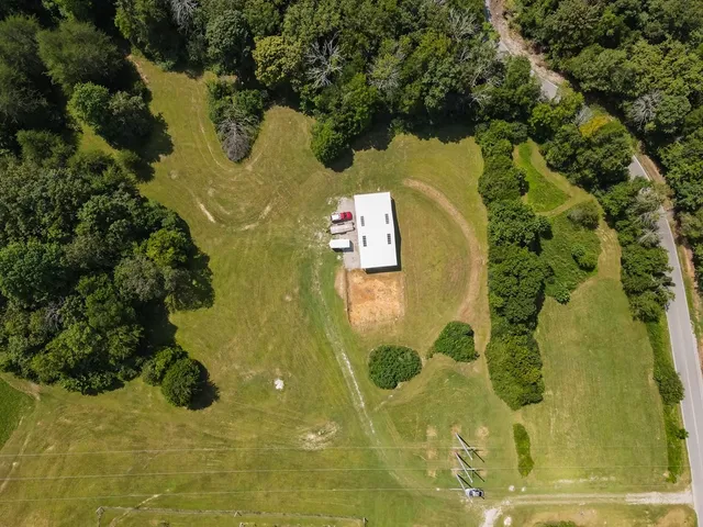 an aerial view of a house with a yard