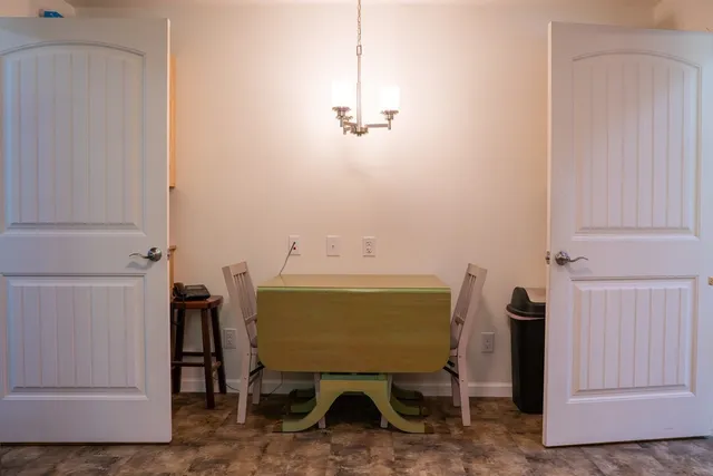 a kitchen with stainless steel appliances granite countertop a stove a sink and dishwasher with white cabinets