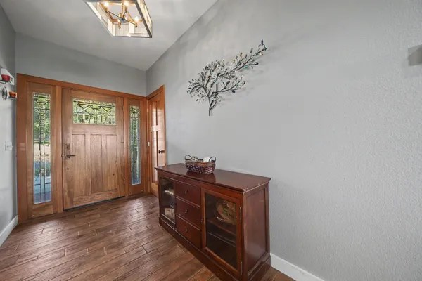a view of a patio with chairs and table under an umbrella
