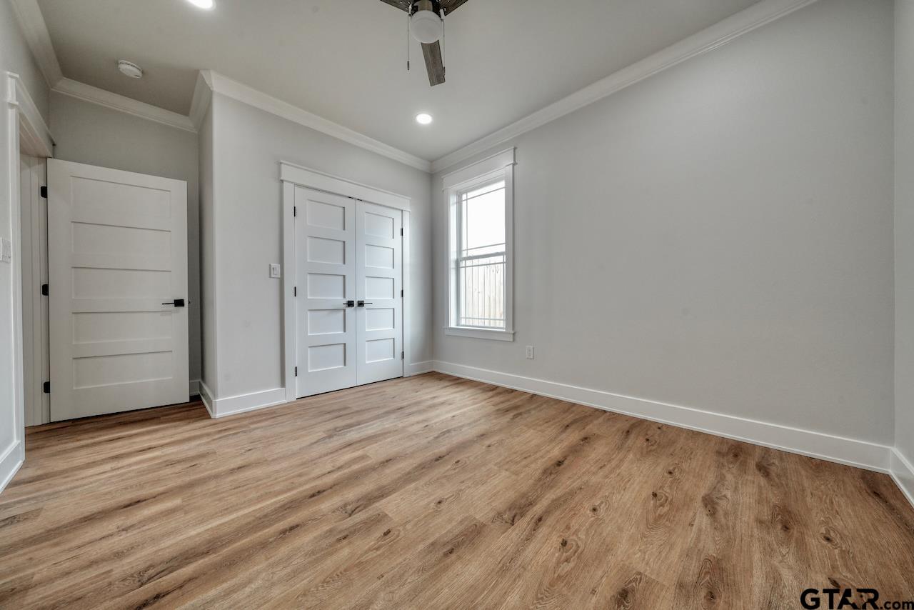 19383 Ridge Point Circle Lindale, TX 75771 - Photo 34 of 48 wooden floor in an empty room with a window