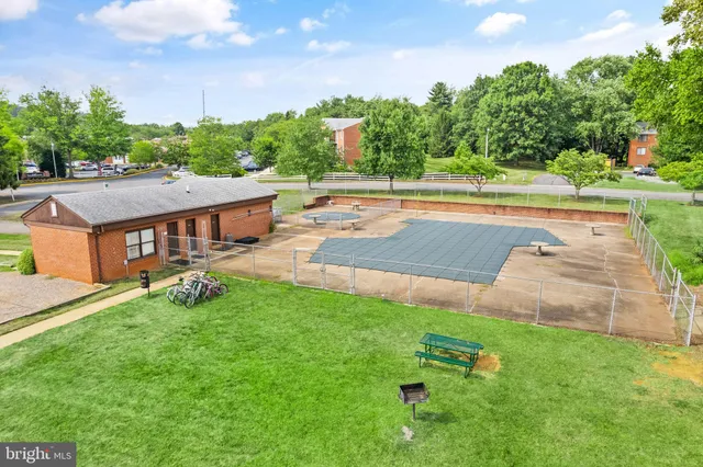 an aerial view of a house with yard and green space