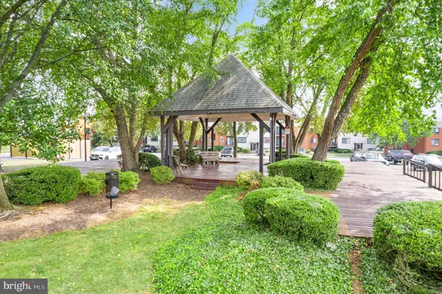 a view of a patio with table and chairs under an umbrella