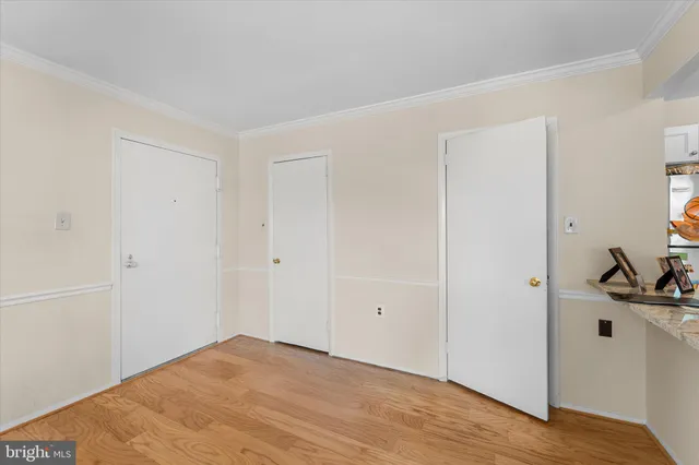 a view of a livingroom with a hardwood floor and a hallway