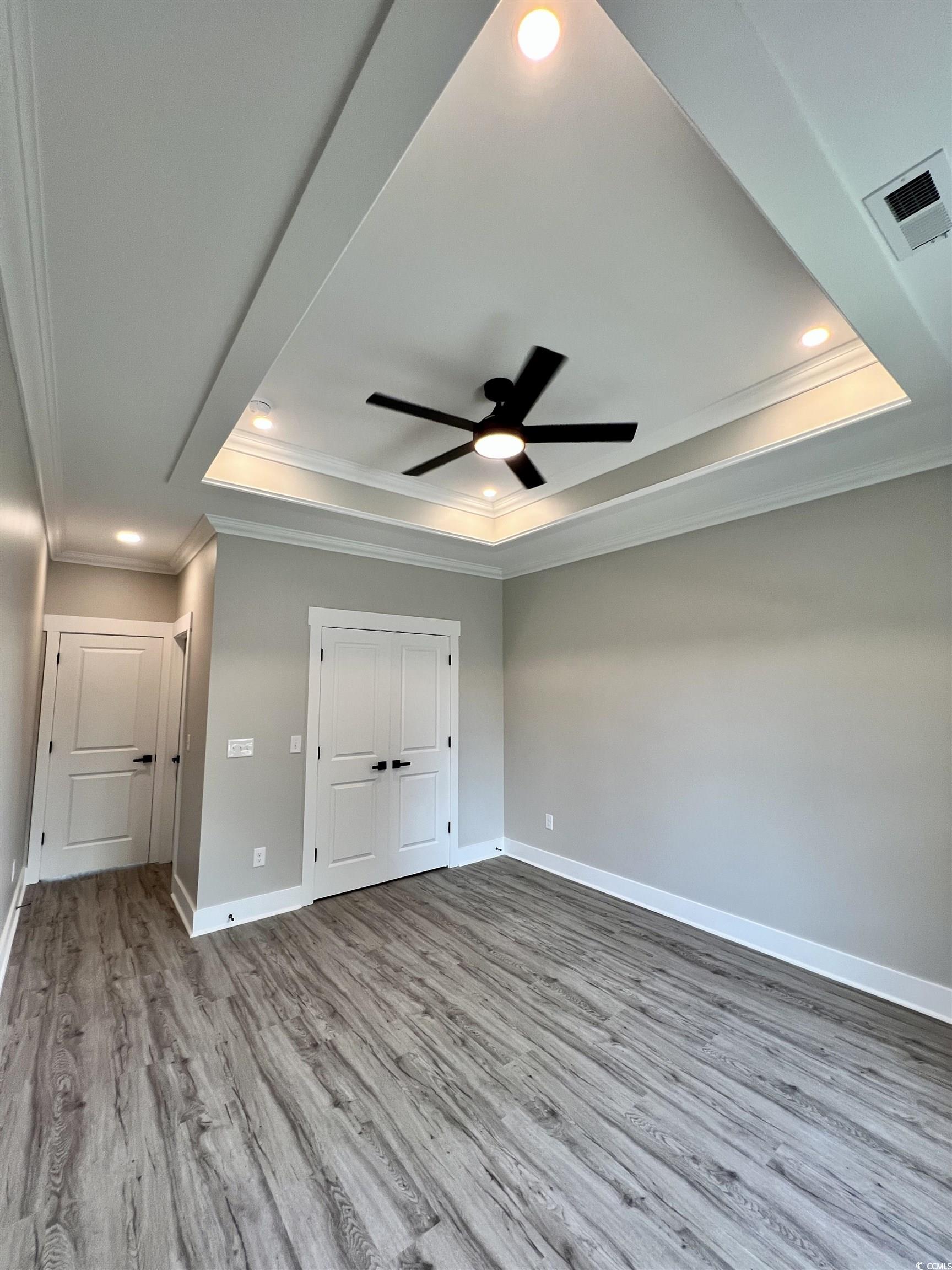 1795 Hemingway Street Conway, SC 29527 - Photo 12 of 29 Unfurnished bedroom featuring crown molding, a tray ceiling, light wood-style flooring, recessed lighting, and a ceiling fan