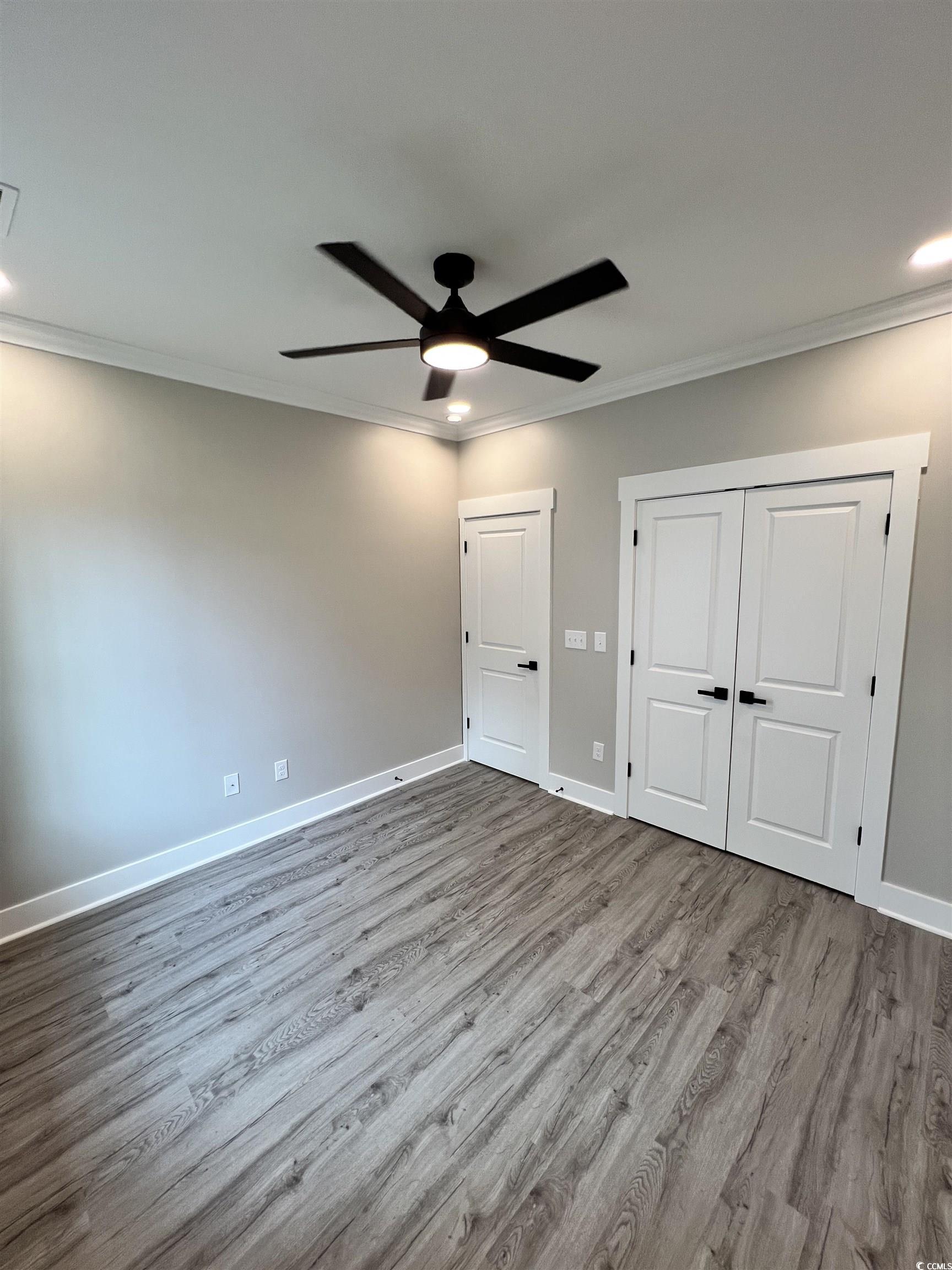 1795 Hemingway Street Conway, SC 29527 - Photo 14 of 29 Unfurnished bedroom with crown molding, wood finished floors, a closet, ceiling fan, and recessed lighting