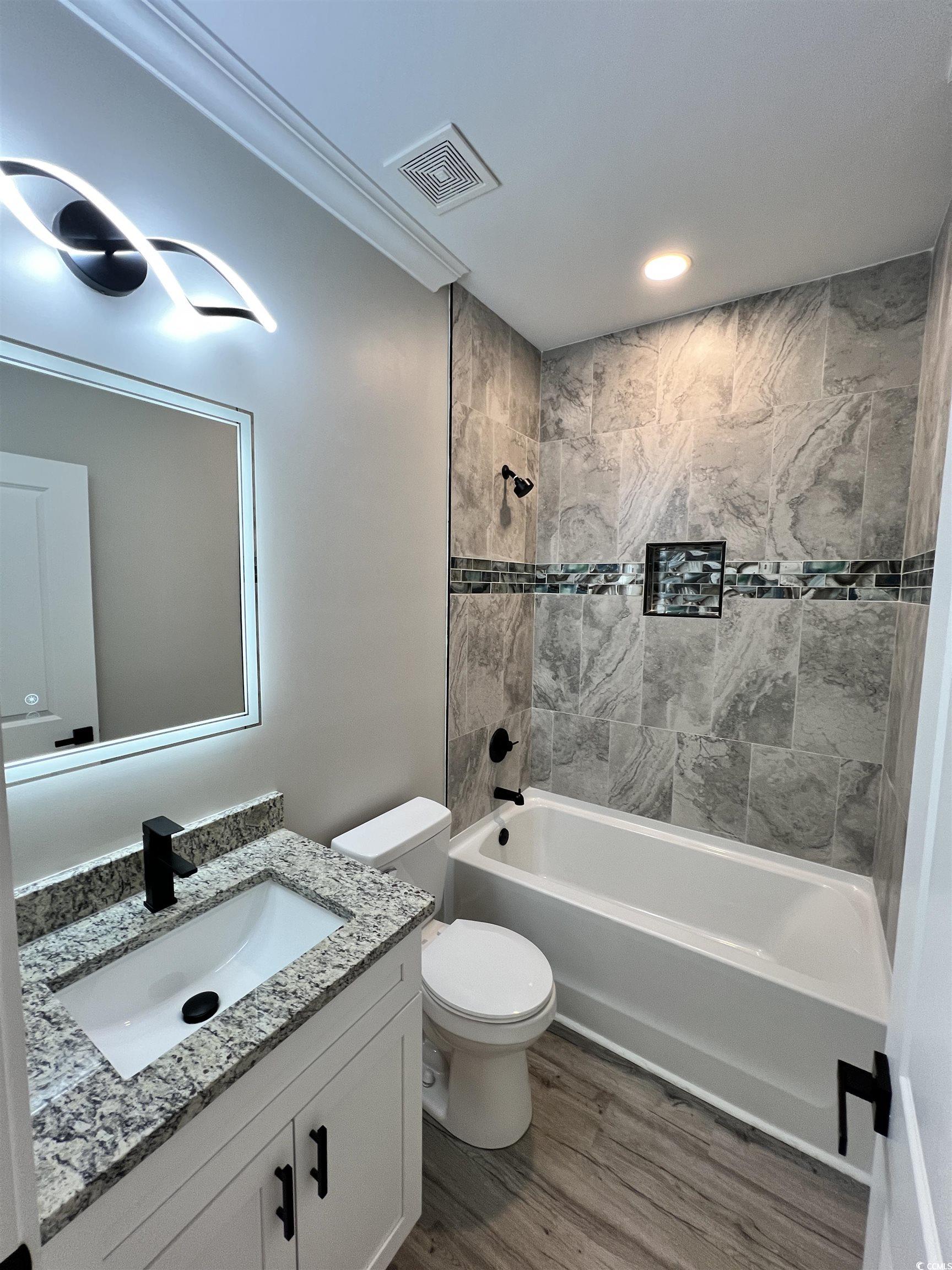1795 Hemingway Street Conway, SC 29527 - Photo 15 of 29 Full bath featuring shower / bathtub combination, vanity, and wood finished floors