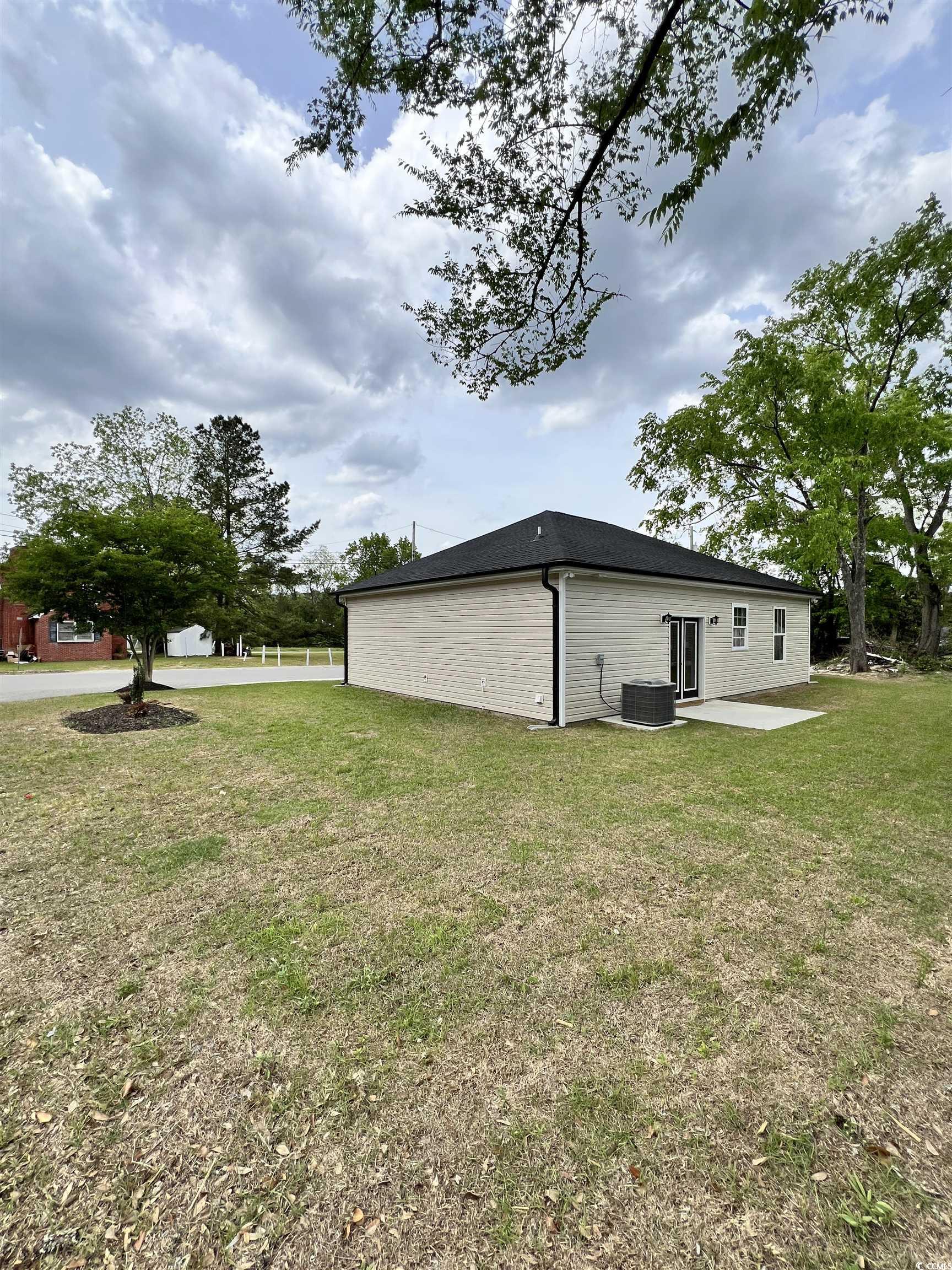 1795 Hemingway Street Conway, SC 29527 - Photo 21 of 29 View of property exterior with a patio and a lawn