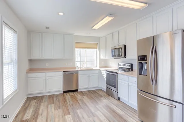 a kitchen with a refrigerator stove and sink