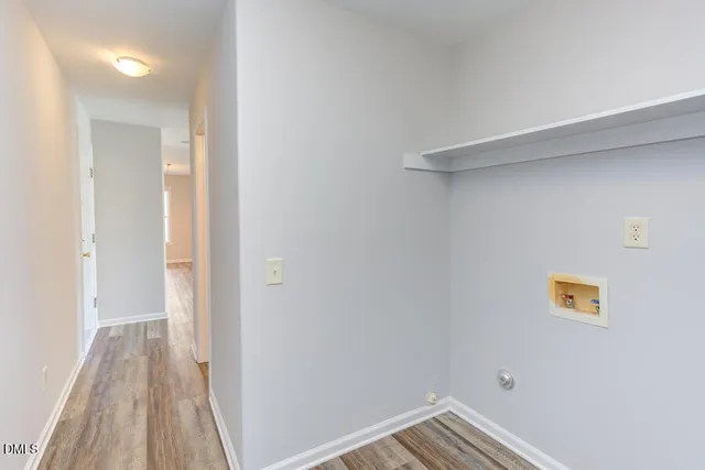 a view of a hallway with a wooden floor