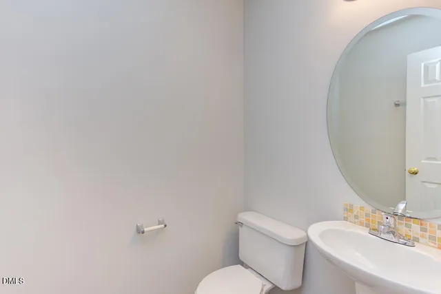 a white toilet sitting next to a bathroom sink