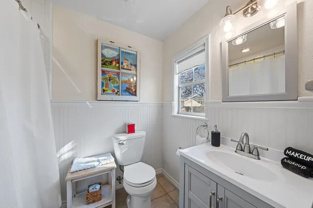 a bathroom with a toilet a sink and a mirror