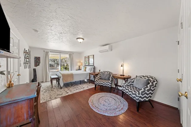 a living room with furniture a rug and a flat screen tv